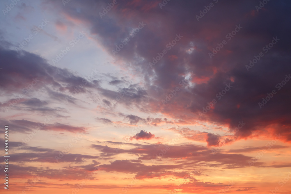 Beautiful bright colorful  pink red yellow clouds on dark sky at sunset or sunrise. Evening or morning sky natural eco background. Amazing nature texture surface wallpaper.