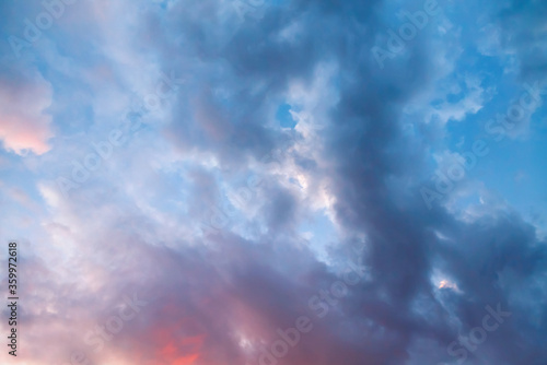Beautiful bright colorful  pink red yellow clouds on dark sky at sunset or sunrise. Evening or morning sky natural eco background. Amazing nature texture surface wallpaper. © anoushkatoronto
