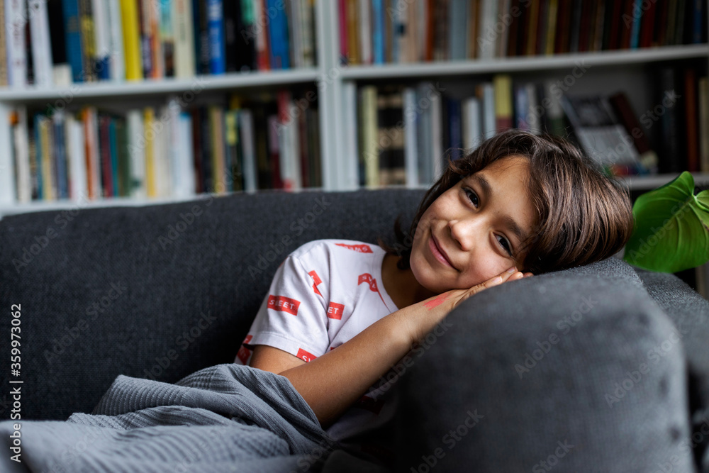 Portrait of smiling boy leaning comfortable sofa in living room at home Portrait of smiling boy leaning comfortable sofa in living room at home