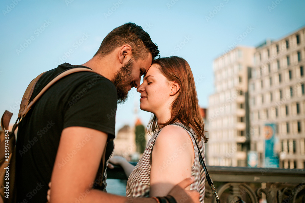 Affectionate young couple on a bridge in the city, Berlin, Germany Affectionate young couple on a bridge in the city, Berlin, Germany