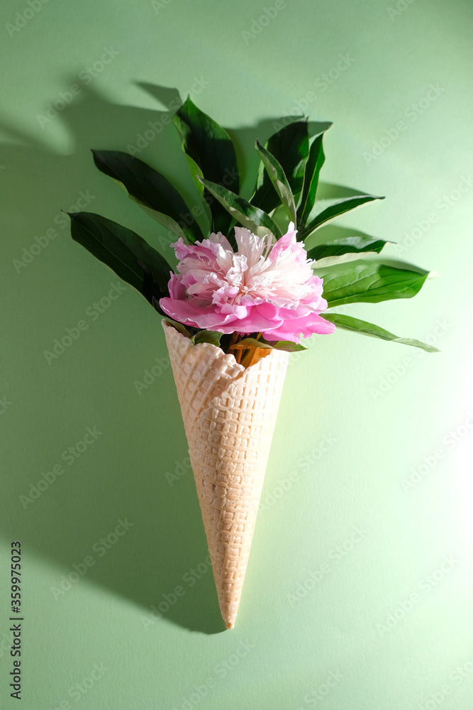 Peony leaf in a waffle cone. Summer concept.
