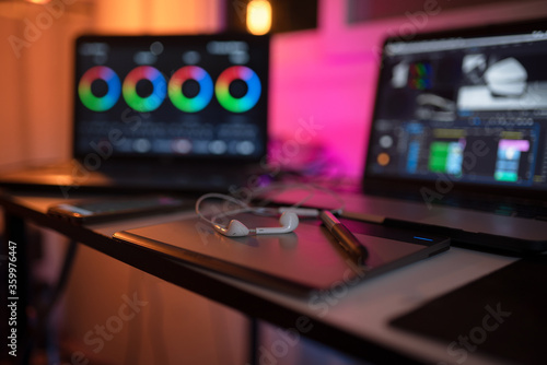 Headphone on the desk content creator and display color grading correction of editor freelance