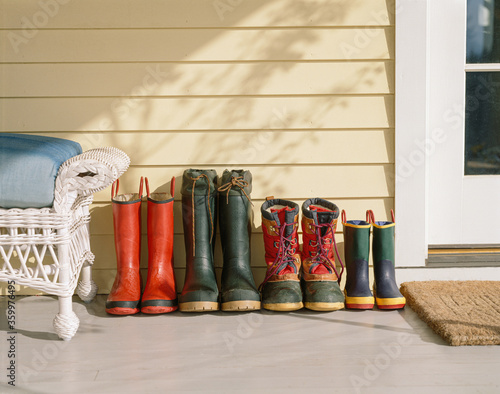 4 pairs of family boots on porch