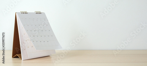 Calendar page flipping sheet on wood table background business schedule planning appointment meeting concept