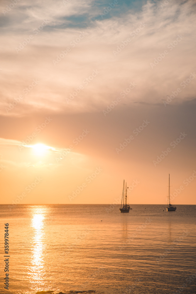 sunset over sea bay with yachts on background