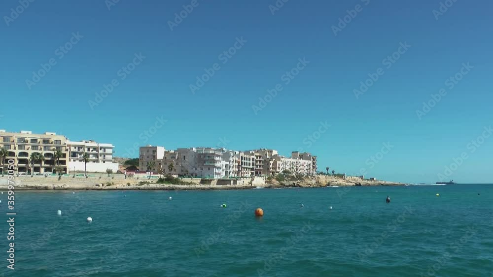 Apartment buildings in Marsaskala bay and ship docked in Mediterranean Sea Apartment buildings in Marsaskala bay and ship docked in Mediterranean Sea