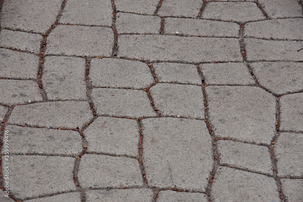 Obraz premium Close-up high angle view of a concrete street pavement with a stone-like stamped pattern