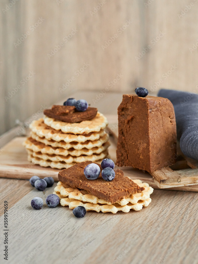Viennese waffles with Norwegian brunost cheese and blueberries. Breakfast with Traditional Scandinavian brown cheese