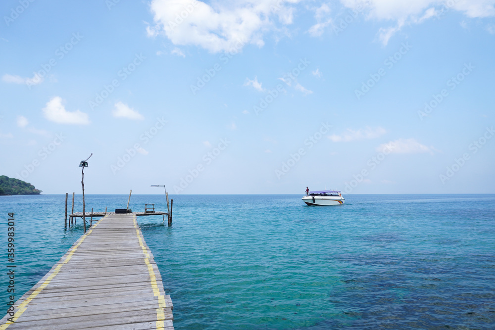 wooden pier in the sea and boat at koh kood, trat, thailand