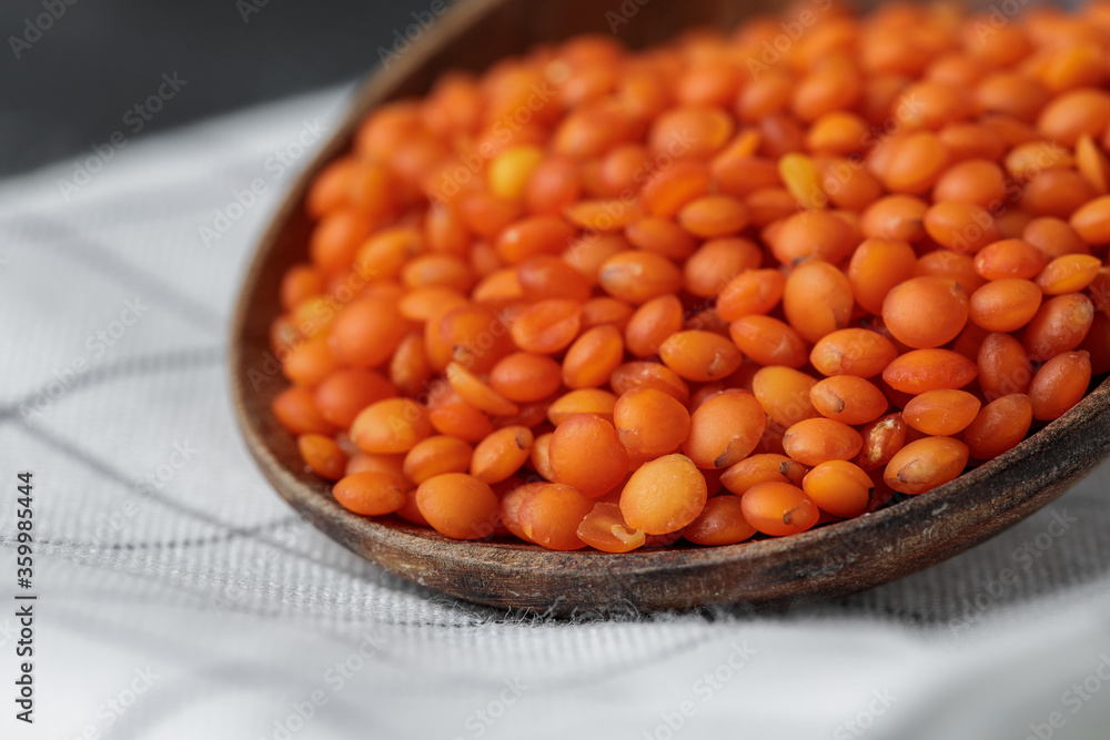 Wooden spoon with red lentils close up Wooden spoon with red lentils close up