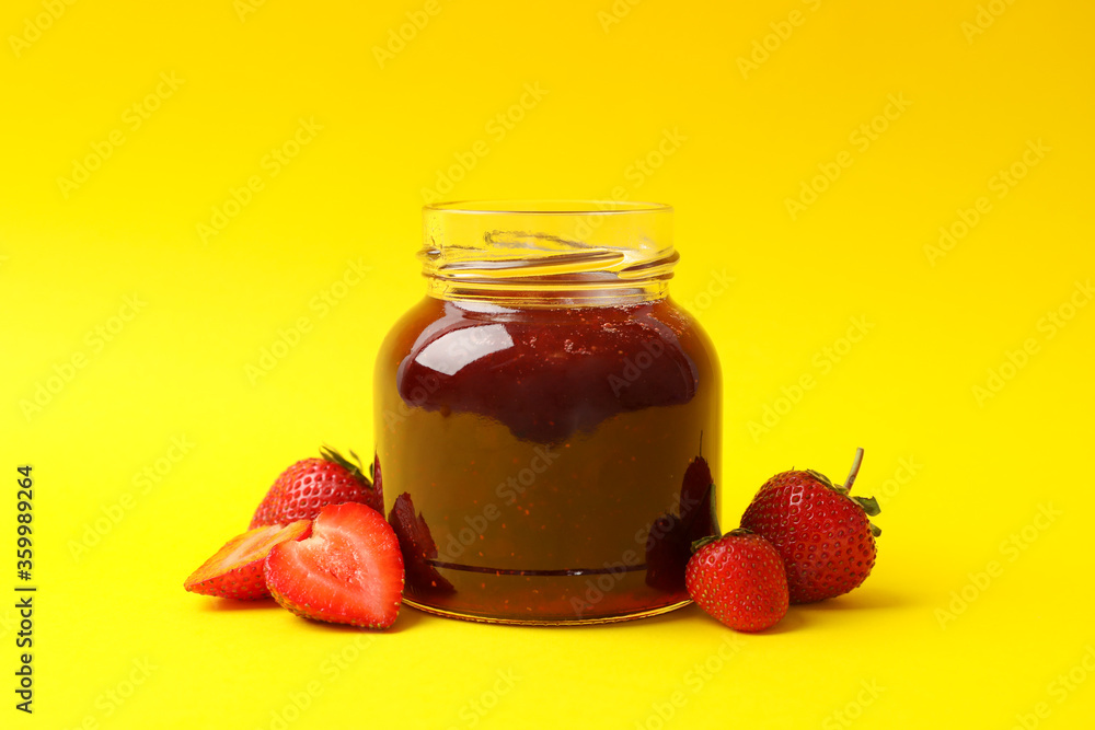 Delicious strawberry jam on yellow background, space for text