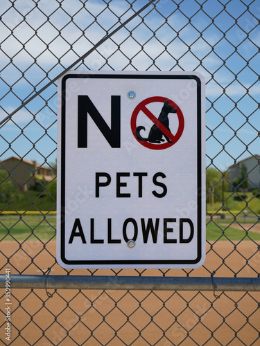 No pets allowed sign on a fence.