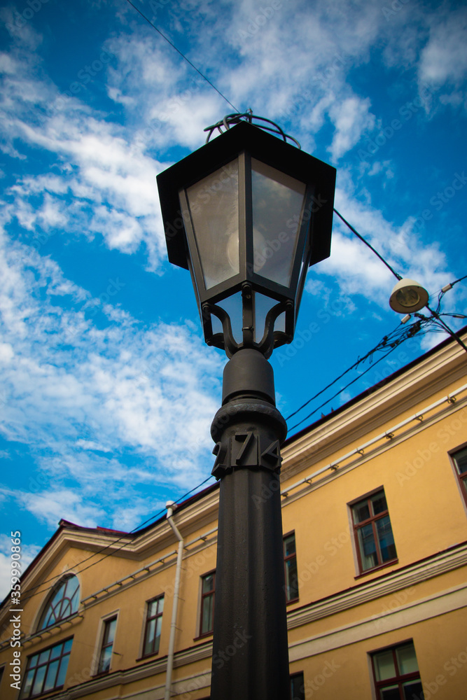 old street lamp on blue sky with clouds background