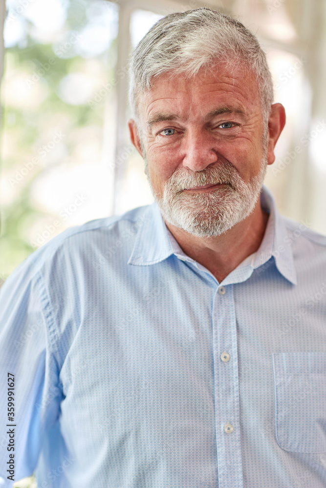 Close-up of a mature businessman standing near a paned window Close-up of a mature businessman standing near a paned window