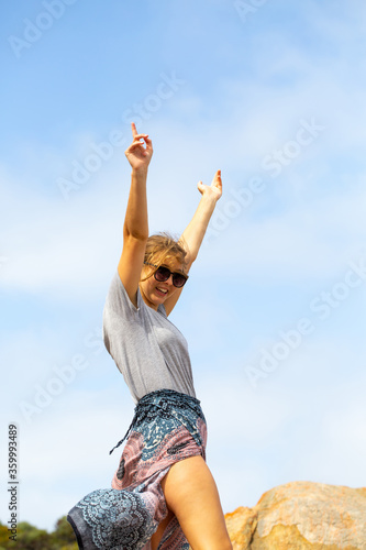 Young woman with arms in the air in exaultation