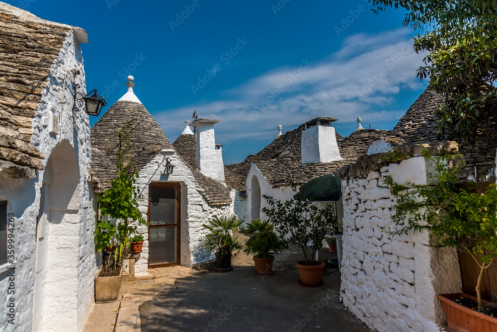 A small cul-de-sac of  traditional Trulli buildings in Alberobello, Bari, Italy in the summertime