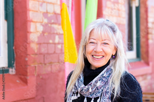 mature woman with long hair head and shoulders view looking at camera