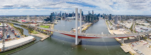 Aerial view of the Bolte Bridge over the Yarra River and Melbourne city skyline in the background photo