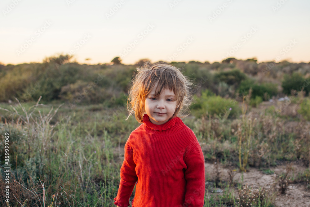 Young girl with messy hair standing in bushland Young girl with messy hair standing in bushland