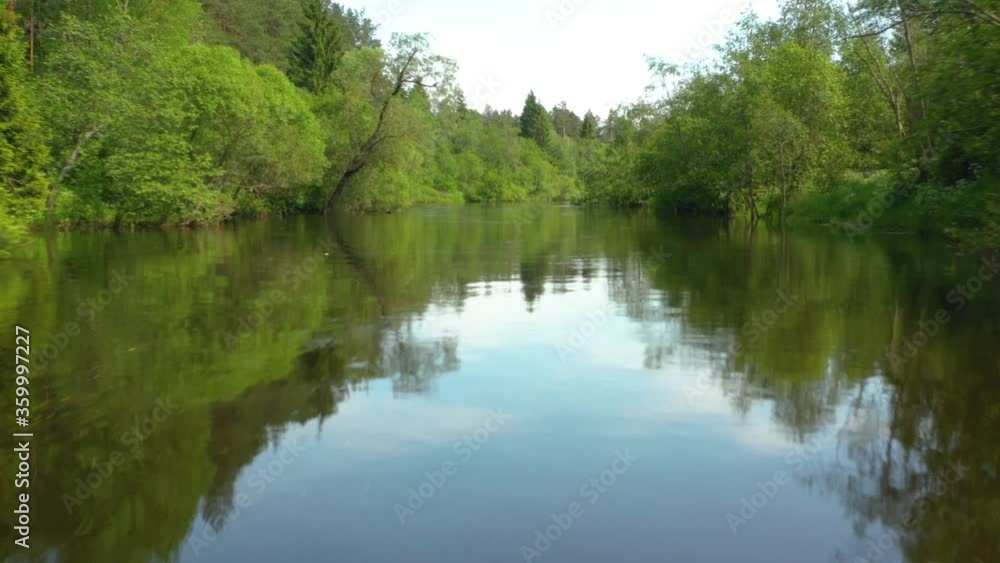 Flying at low altitude over river in deep green forest, Moscow area, Russia Flying at low altitude over river in deep green forest, Moscow area, Russia