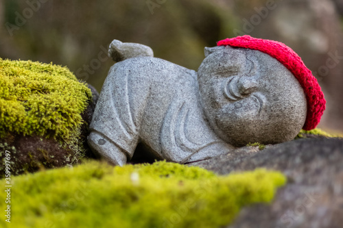 Jizo Buddhist statues with red cap at Daisho-in Temple, Miyajima, Japan - Daishoin Temple is known for it's over 500 statues in different shapes and sizes. Hidden wonder on Miyajima's Mount Misen. photo