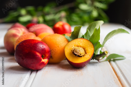 stone fruits on a wooden white background photo