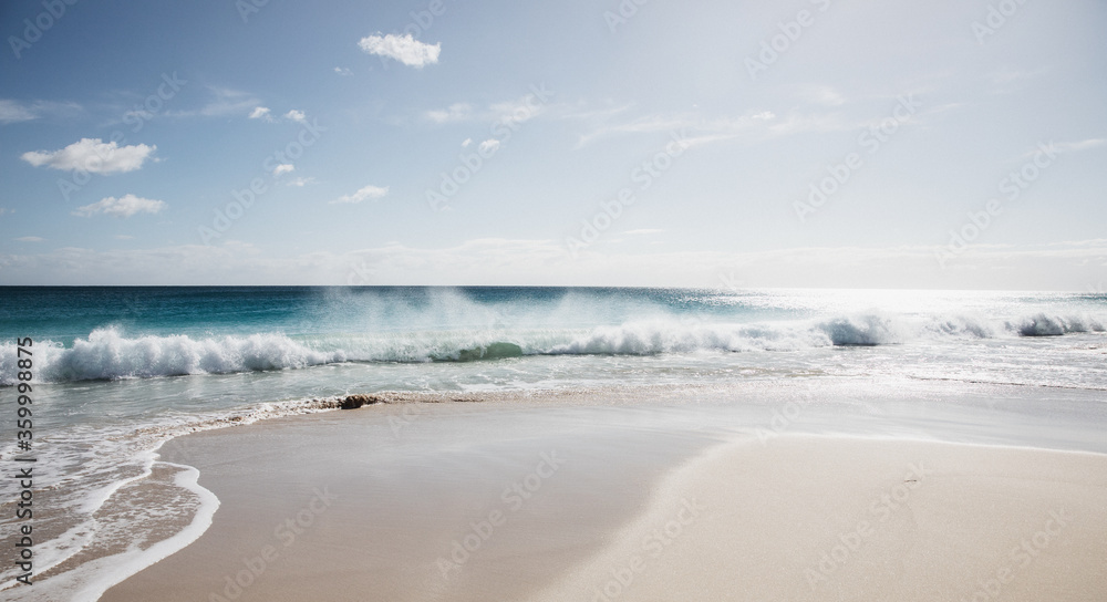 Waves on empty beach in morning light Waves on empty beach in morning light