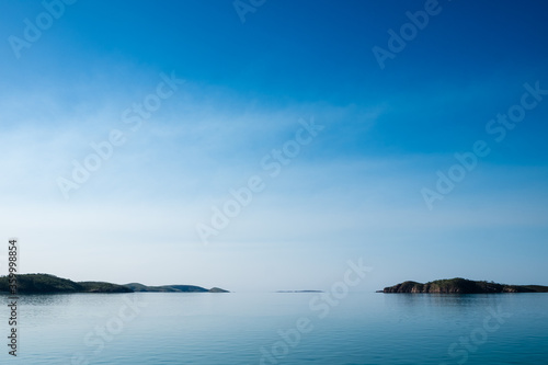 Islands in the distance through glassed off water in remote location