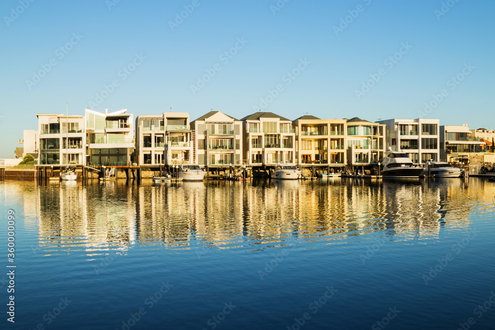 Marina homes reflecting in the water in morning light Marina homes reflecting in the water in morning light