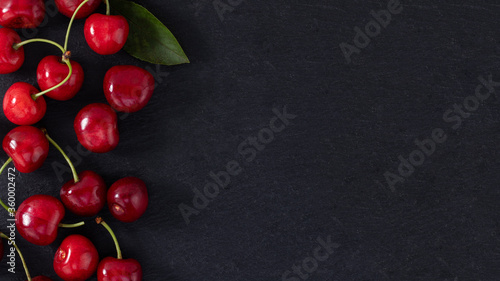 cherry on dark background with copy space. Top view. Flat lay