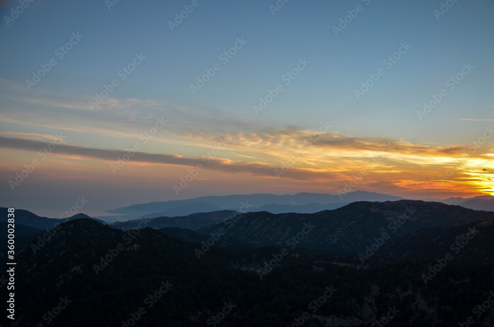 Beautiful mountain landscape with sunset over Taurus Mountains from the top of Tahtali Mountain near Kemer, Antalya, Turkey. 