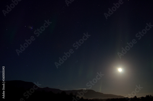 full moon, aurora borealis and clouds © Arcticphotoworks