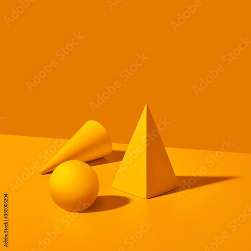 Plaster geometric shapes on a yellow background.