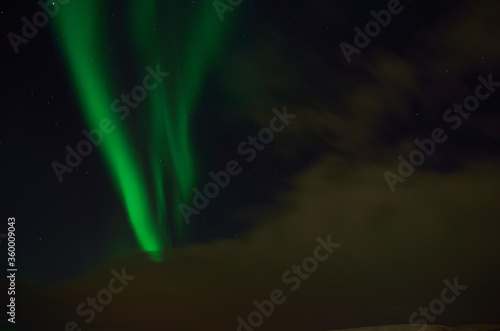 Vivid green aurora borealis, northern light on late autumn night sky © Arcticphotoworks