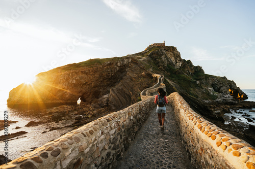 woman walking forward to the chapel in Gaztelugatxe island
