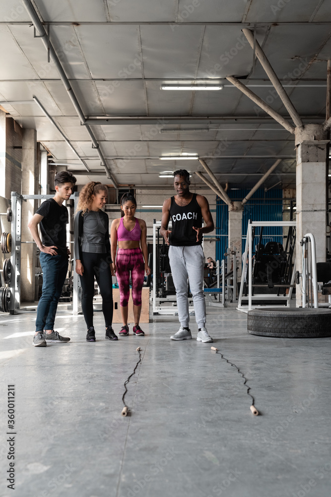 Coach explaining exercise to athletes Coach explaining exercise to athletes
