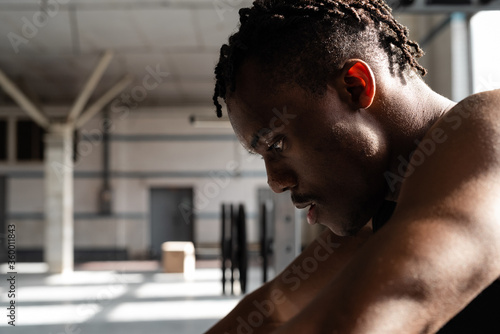 Sweaty black athlete in gym
