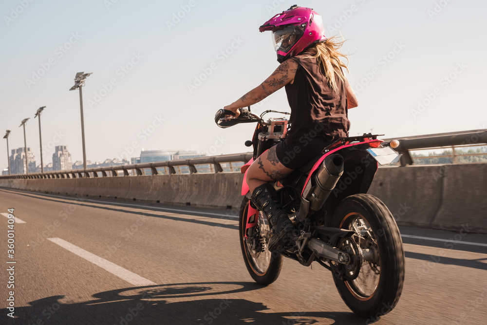 girl riding pink motorcycle