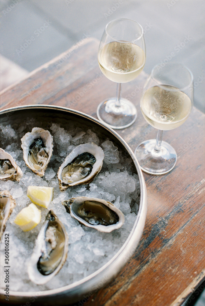 two glasses with white wine and oysters two glasses with white wine and oysters