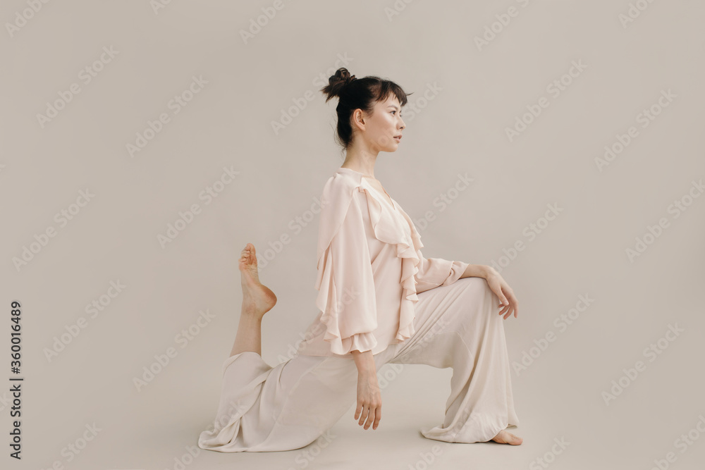 Elegant Asian woman doing lunges Elegant Asian woman doing lunges