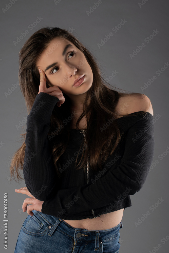 Fototapeta premium Girl posing on grey background. Isolated