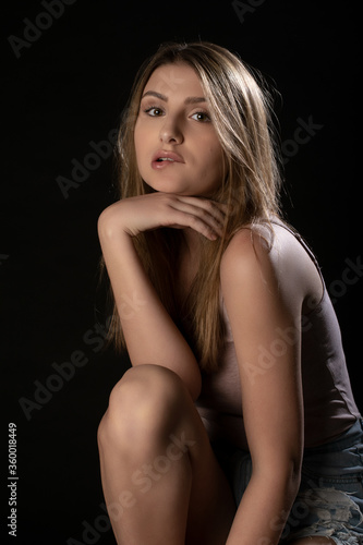 Beautiful girl posing on black background. Isolated, Face Expression