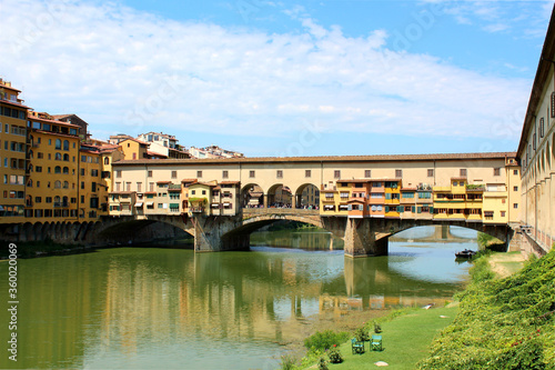 Ponte Vecchio, an ancient bridge across Arno river, in city Florence, Italy in a beautiful summer day.