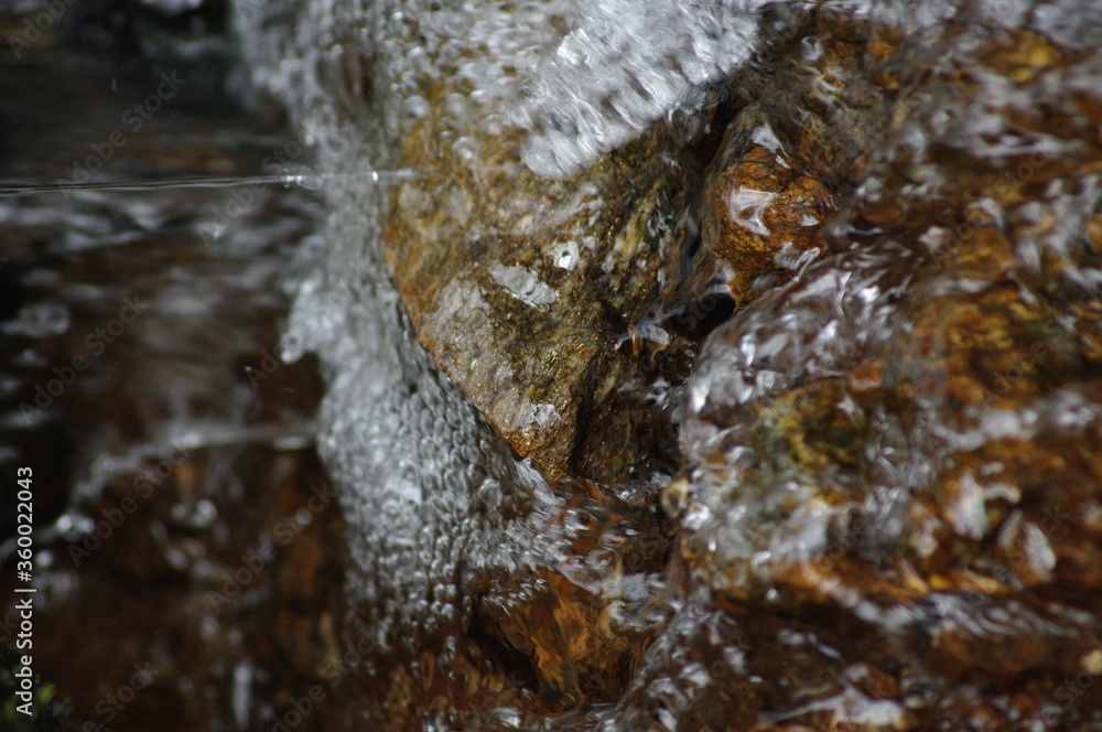 Crystal splashes of water, playful foam in the streams of the river. Stones under the streams of a swift, mountain river... Crystal splashes of water, playful foam in the streams of the river. Stones under the streams of a swift, mountain river...