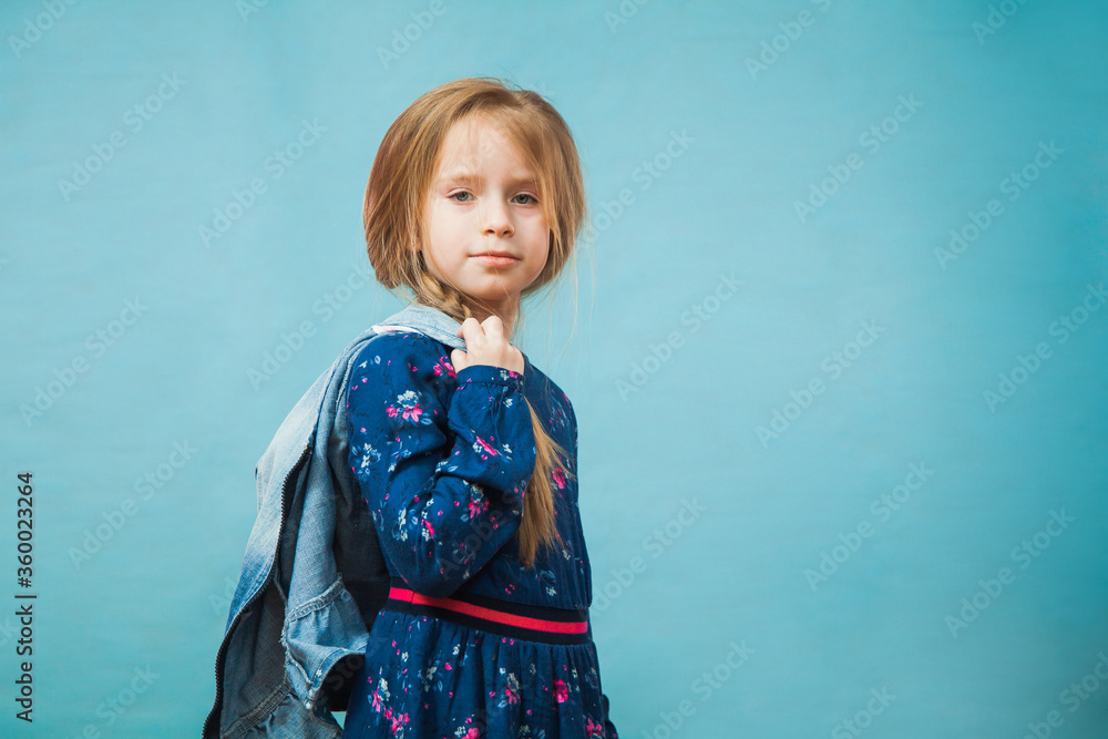 Pretty preteen girl in casual blue dress smile. Positive emotion, copy space for text, advertising concept. Pretty preteen girl in casual blue dress smile. Positive emotion, copy space for text, advertising concept.