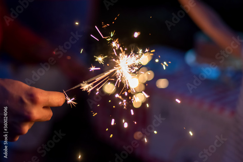 Lighting sparklers in the backyard on a summer evening