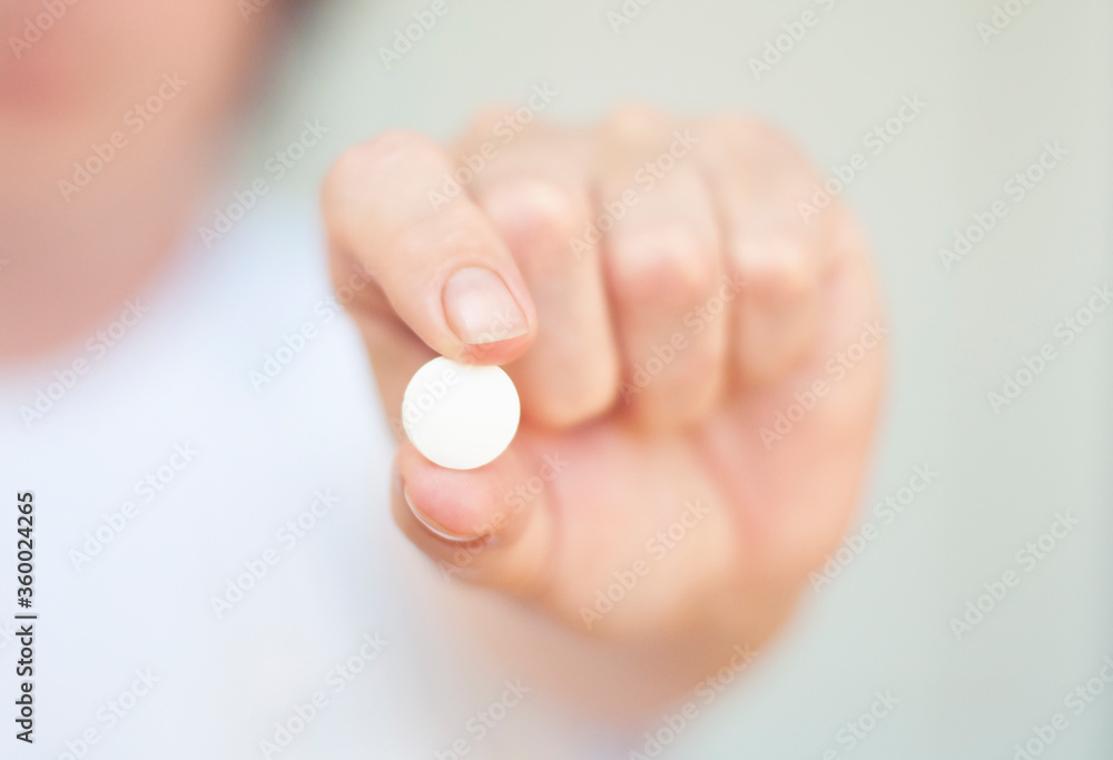 woman holding white tablet in the hand woman holding white tablet in the hand