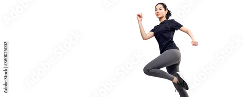 Full length portrait of fitness woman in sportswear jumping. © Galaxy_love_design