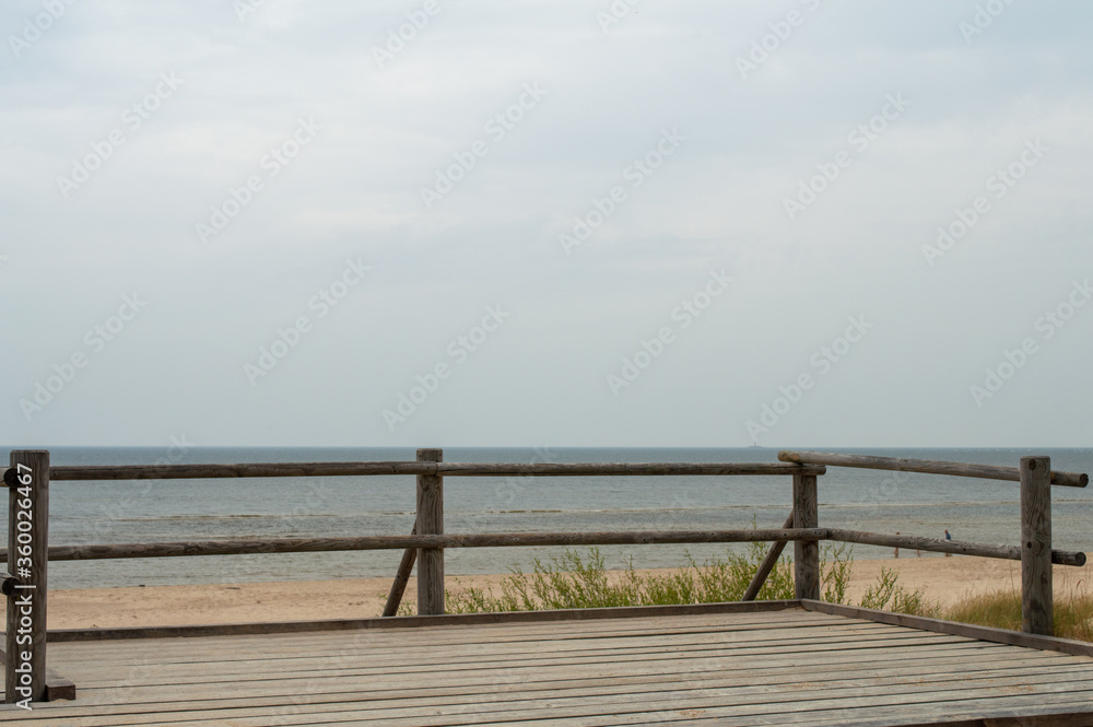 wooden viewpoint deck against a quiet calm sea landscape
