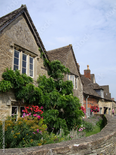 A street view with old stone houses in nine hundred years old Lacock village, in Wiltshire, England, UK.
